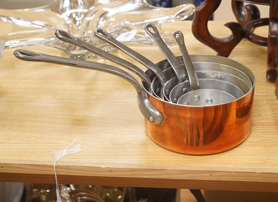 A set of five French graduated iron handled copper saucepans, largest 18.5cm diameter. Condition - good